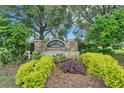 Stone entrance sign to Dover Grove Estates amidst lush landscaping at 13102 Done Groven Dr, Dover, FL 33527
