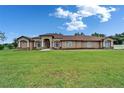 Beautiful single-story home boasting well-manicured lawn and mature landscaping, enhancing its curb appeal at 13102 Done Groven Dr, Dover, FL 33527