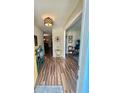 Inviting entryway featuring wood-look flooring and an open view to the living spaces at 1814 Driftwood S Cir, Oldsmar, FL 34677