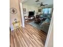 Cozy living room with wood floors, comfortable sofa, and bright natural light at 1814 Driftwood S Cir, Oldsmar, FL 34677