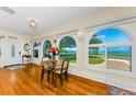 Bright dining area with stunning water views through arched windows, enhancing the home's appeal at 1951 Edgewater Dr, Clearwater, FL 33755