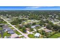 Expansive aerial view showcasing a lush residential neighborhood with tree-lined streets and varied home styles at 20352 Astoria Ave, Port Charlotte, FL 33952
