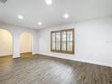 Bright living room boasts modern flooring, neutral walls, recessed lighting and arched doorway at 20352 Astoria Ave, Port Charlotte, FL 33952