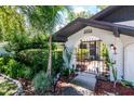 Close up of the address and a wrought iron gated courtyard with nice landscaping at 23924 Forest Pl, Land O Lakes, FL 34639