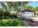 Well kept home with a two-car garage, beautiful landscaping, and a wrought iron gated courtyard at 23924 Forest Pl, Land O Lakes, FL 34639