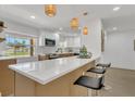 Bright kitchen featuring modern lighting, quartz countertops, and stylish bar seating at 2837 Woodcrest Dr, Sarasota, FL 34239