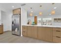 Open concept kitchen with stainless steel refrigerator, and breakfast bar at 2837 Woodcrest Dr, Sarasota, FL 34239