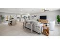 Open-concept living space with kitchen and dining areas, modern furniture, and seamless flow to other rooms at 2905 Forest Cir, Seffner, FL 33584