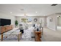 Bright living room with natural light, neutral tones, tile floors, modern furnishings, and view to the front yard at 2905 Forest Cir, Seffner, FL 33584
