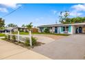 Charming single-story home with a brick driveway, white picket fence, and well-manicured lawn at 3015 Florida Blvd, Bradenton, FL 34207