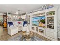 Bright and airy living room with white furniture, a large entertainment center, and a stylish rug at 3015 Florida Blvd, Bradenton, FL 34207