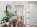Stylish entryway features modern lighting, wood floors, a decorative mirror, and bright, neutral decor at 303 N Beverly Ave, Tampa, FL 33609