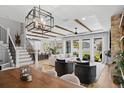 Open-concept living room boasts natural light, modern decor, wood beams, and seamless flow to the outdoors at 303 N Beverly Ave, Tampa, FL 33609