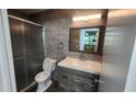 Modern bathroom with gray tile, updated vanity, and glass enclosed shower at 3123 29Th N Ave # 105, St Petersburg, FL 33713
