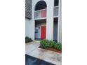 Exterior view of building entrance featuring covered walkway and manicured shrubbery at 3123 29Th N Ave # 105, St Petersburg, FL 33713