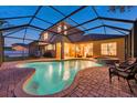 Inviting screened-in pool and spa offer a relaxing outdoor retreat with ample space for lounging and entertaining at 31646 Baymont Loop, Wesley Chapel, FL 33543
