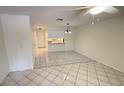 Bright living room with tile flooring and a view into the open-concept kitchen at 4003 Oak Limb Ct, Tampa, FL 33614