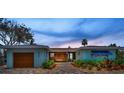 Beautiful single-story house featuring a custom wood entry and meticulously landscaped front yard at 4381 Poinsettia Dr, St Pete Beach, FL 33706