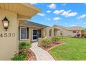 Inviting front entrance with landscaped walkway and decorative pillars leading to the front door at 4530 Zack Dr, New Port Richey, FL 34653