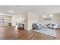 Open concept living room with wood floors, wainscoting, and neutral paint colors at 4530 Zack Dr, New Port Richey, FL 34653