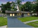Charming single-story home with a well-maintained lawn and a gray brick exterior at 4906 Presidential St, Seffner, FL 33584