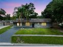 Charming single-story home with a well-maintained lawn and a gray brick exterior at 4906 Presidential St, Seffner, FL 33584