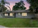 Charming single-story home with a well-maintained lawn and a gray brick exterior at 4906 Presidential St, Seffner, FL 33584