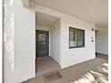 Inviting entryway with a welcome mat, neutral color scheme and an exterior window at 700 Starkey Rd # 311, Largo, FL 33771