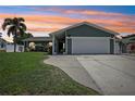 Charming home with a two-car garage, well-maintained lawn, and lush landscaping at 852 Crystal Dr, Palm Harbor, FL 34683