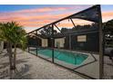 Screened in pool with lighting for evening swims at 852 Crystal Dr, Palm Harbor, FL 34683