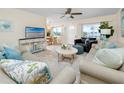 Bright living room with tile floors, ceiling fan, stylish furniture, and plenty of natural light at 8584 111Th St # 308, Seminole, FL 33772