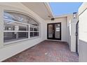 Close up of the home's brick paved entryway, double-door entrance, and an arched window at 11225 4Th E St, Treasure Island, FL 33706