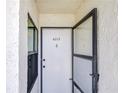 Front door with security door and unit number at 14130 Rosemary Ln # 4215, Largo, FL 33774