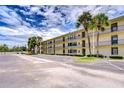 Large three story building with parking lot and landscaping at 14130 Rosemary Ln # 4215, Largo, FL 33774