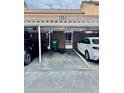 Covered parking area offering convenient parking and protection for vehicles with an adjacent door at 1884 Clearbrooke Dr, Clearwater, FL 33760