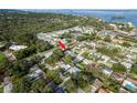 Aerial view of a neighborhood highlighting the location of the house with mature trees and proximity to the water at 2005 Jefferson Ave, Dunedin, FL 34698