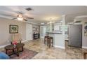 Inviting open-concept living space with tile floors, a ceiling fan, and a view into the kitchen at 2005 Jefferson Ave, Dunedin, FL 34698