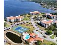 Aerial view of condos with community pool, tennis courts and waterfront views at 244 & 243 Mariner Dr # 243-244, Tarpon Springs, FL 34689