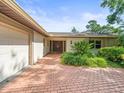 Home features brick paved walkway leading to double front doors and attached garage at 4209 Winding Willow Dr, Tampa, FL 33618