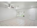 Bright living room with neutral tile flooring, a ceiling fan, and a front-facing window with blinds at 456 Summer Sails Dr, Valrico, FL 33594