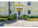 Charming yellow two-story home featuring a well-maintained front yard and a covered front entrance with white trim at 4984 Beach Se Dr # B, St Petersburg, FL 33705