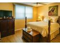 Well-lit bedroom with furnishings, wood floors, and a ceiling fan at 5623 80Th N St # 406, St Petersburg, FL 33709