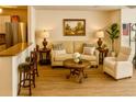Cozy living room showcasing stylish furniture, wood floors, and natural light at 5623 80Th N St # 406, St Petersburg, FL 33709