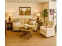 Comfortable living room featuring a couch, chair, tables, and decor at 5623 80Th N St # 406, St Petersburg, FL 33709