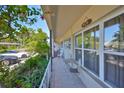 Relaxing tiled balcony features seating, lush plants, and serene neighborhood views at 5695 40Th N Ave # 301, Kenneth City, FL 33709