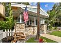 Inviting front porch with stone columns and an American flag displayed at 711 S Bungalow Ter, Tampa, FL 33606