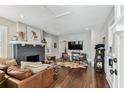 Comfortable living room with a dark brick fireplace and hardwood floors at 711 S Bungalow Ter, Tampa, FL 33606