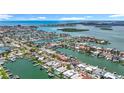 Breathtaking aerial view of the coastal community, showcasing stunning waterfront properties and waterways at 760 Capri Blvd, Treasure Island, FL 33706