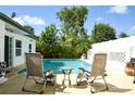 Backyard showcasing a refreshing in-ground pool with lounge chairs for relaxing by the water at 7699 92Nd St, Seminole, FL 33777