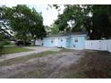 Light blue single-Gathering home featuring landscaped yard, fenced-in backyard at 8405 N Willow Ave, Tampa, FL 33604